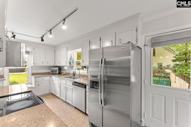 6304 Christie Rd, Columbia, SC 29209 - kitchen with stainless steel appliances, a sink, white cabinetry, light countertops, and crown molding