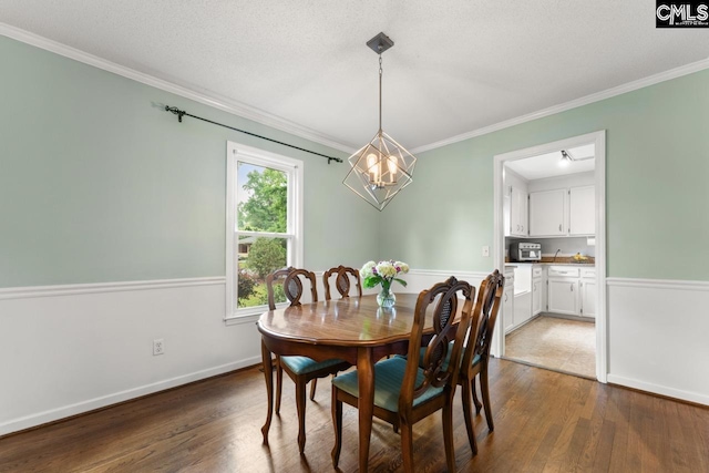 6304 Christie Rd, Columbia, SC 29209 - dining room with a chandelier, dark wood-style floors, ornamental molding, and baseboards