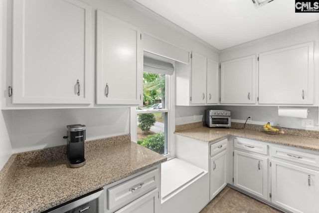 6304 Christie Rd, Columbia, SC 29209 - kitchen featuring white cabinetry, crown molding, light tile patterned flooring, and light stone countertops