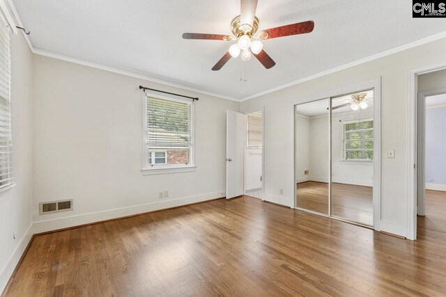 200 Shady Ln, Cayce, SC 29033 - unfurnished bedroom with wood finished floors, crown molding, baseboards, a closet, and ceiling fan