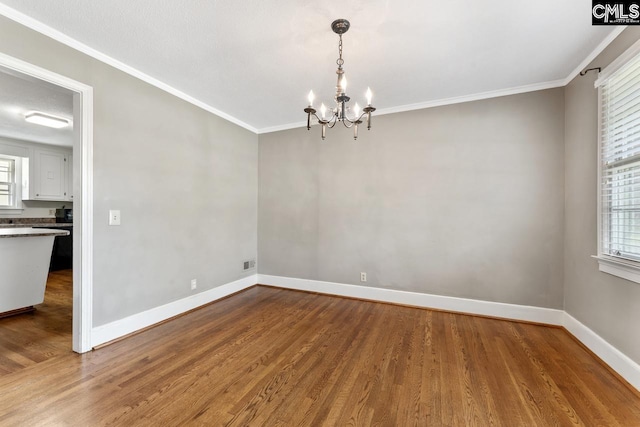 200 Shady Ln, Cayce, SC 29033 - empty room featuring a chandelier, wood finished floors, baseboards, and crown molding