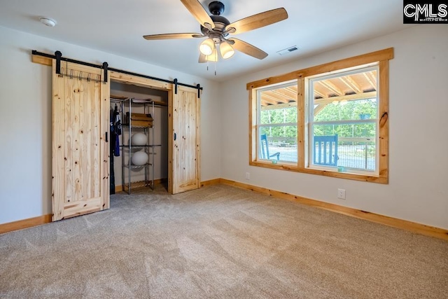 735 Fletcher Dr, Kershaw, SC 29067 - unfurnished bedroom featuring a barn door, carpet flooring, baseboards, and a closet