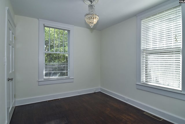 2336 Park St, Columbia, SC 29201 - empty room featuring dark wood-style floors, baseboards, and a chandelier