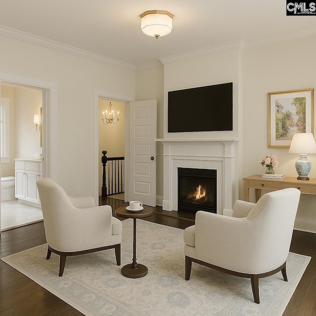 2336 Park St, Columbia, SC 29201 - living area featuring crown molding, wood finished floors, a lit fireplace, and a chandelier