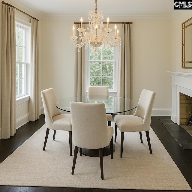 2336 Park St, Columbia, SC 29201 - dining area with dark wood-type flooring, a chandelier, baseboards, and crown molding