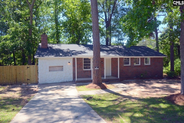 4257 Donavan Dr, Columbia, SC 29210 - view of front of property featuring a chimney, driveway, and stone siding
