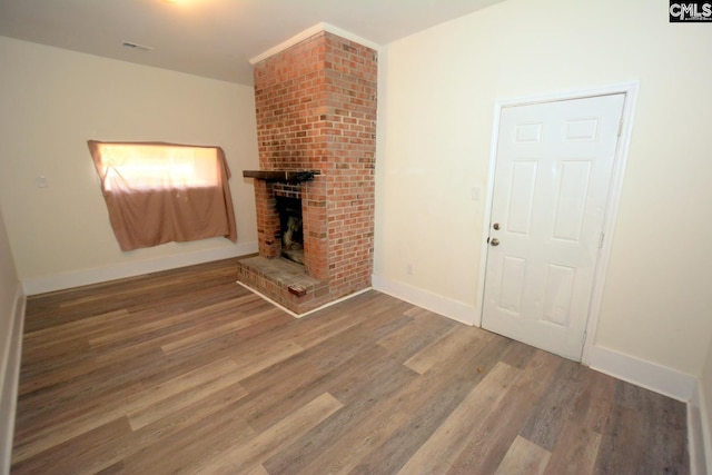4257 Donavan Dr, Columbia, SC 29210 - unfurnished living room featuring wood finished floors, baseboards, and a fireplace