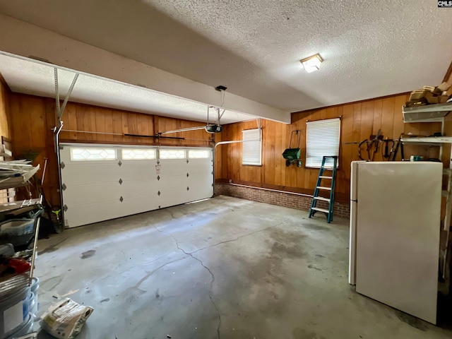 117 Fire Thorn Ln, Columbia, SC 29223 - garage with freestanding refrigerator, wood walls, and a garage door opener