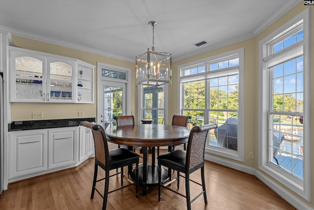 132 Magnolia Key Dr, Chapin, SC 29036 - dining room with a chandelier, wood finished floors, crown molding, and baseboards