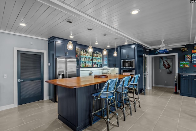 132 Magnolia Key Dr, Chapin, SC 29036 - kitchen featuring butcher block counters, stainless steel appliances, light tile patterned floors, a kitchen bar, and recessed lighting
