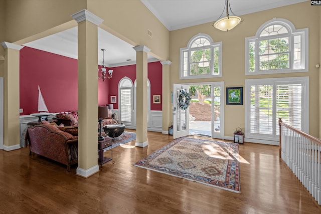 132 Magnolia Key Dr, Chapin, SC 29036 - foyer featuring ornate columns, ornamental molding, a high ceiling, wood finished floors, and a chandelier
