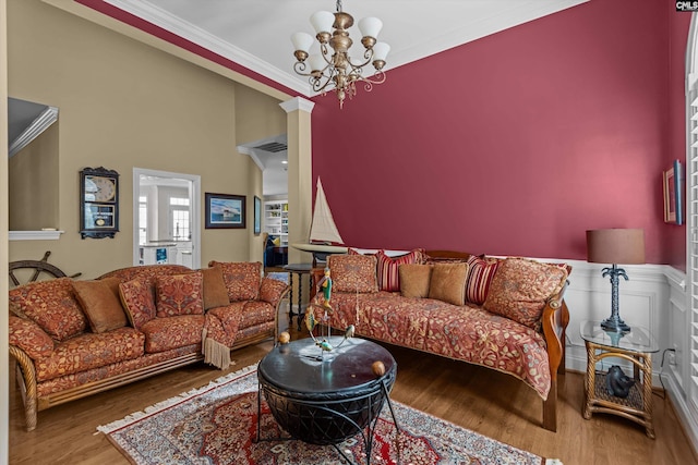 132 Magnolia Key Dr, Chapin, SC 29036 - living area with ornamental molding, wood finished floors, a chandelier, and wainscoting