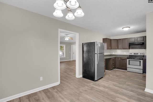 220 Colchester Dr, Columbia, SC 29223 - kitchen featuring appliances with stainless steel finishes, a chandelier, light wood-style floors, baseboards, and a textured ceiling