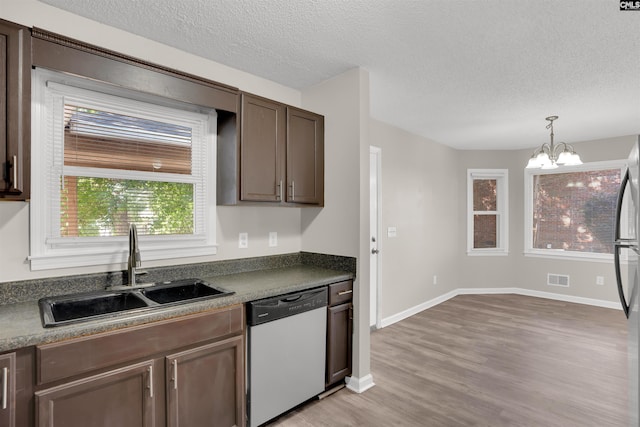 220 Colchester Dr, Columbia, SC 29223 - kitchen with dishwasher, a sink, light wood finished floors, a textured ceiling, and a chandelier