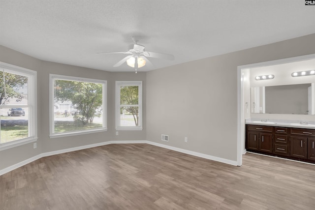 220 Colchester Dr, Columbia, SC 29223 - unfurnished bedroom featuring light wood-style flooring, baseboards, connected bathroom, and a sink