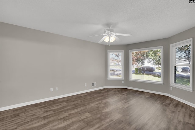 220 Colchester Dr, Columbia, SC 29223 - unfurnished room featuring dark wood-type flooring, baseboards, a ceiling fan, and a textured ceiling