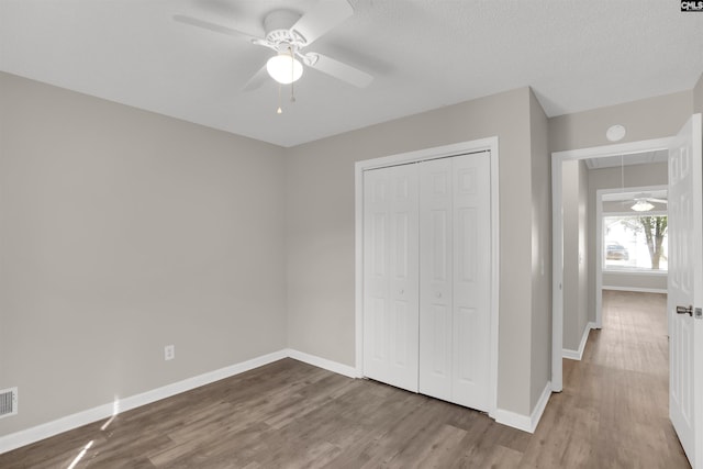 220 Colchester Dr, Columbia, SC 29223 - unfurnished bedroom with attic access, wood finished floors, baseboards, a closet, and a ceiling fan