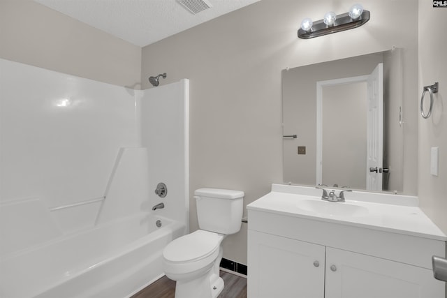 220 Colchester Dr, Columbia, SC 29223 - full bathroom featuring vanity, toilet, tub / shower combination, wood finished floors, and a textured ceiling