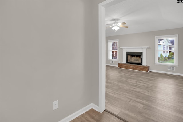 220 Colchester Dr, Columbia, SC 29223 - unfurnished living room featuring wood finished floors, baseboards, a ceiling fan, and a fireplace