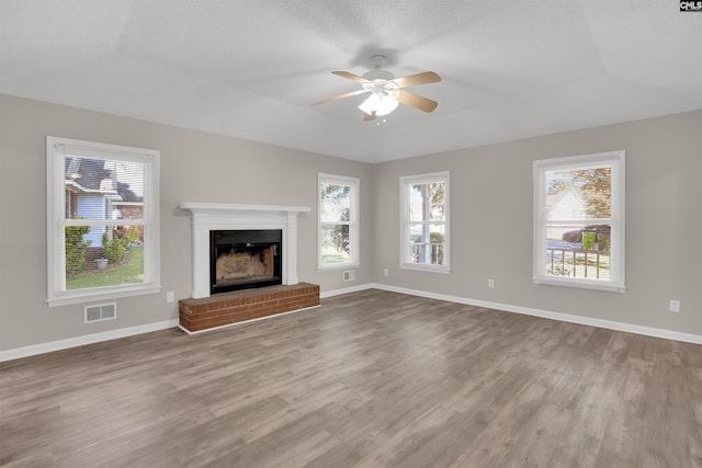 220 Colchester Dr, Columbia, SC 29223 - unfurnished living room featuring healthy amount of natural light, wood finished floors, a fireplace, and a ceiling fan
