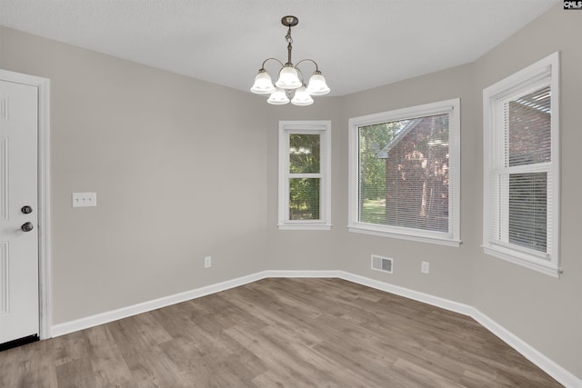 220 Colchester Dr, Columbia, SC 29223 - unfurnished dining area with wood finished floors, a chandelier, and baseboards