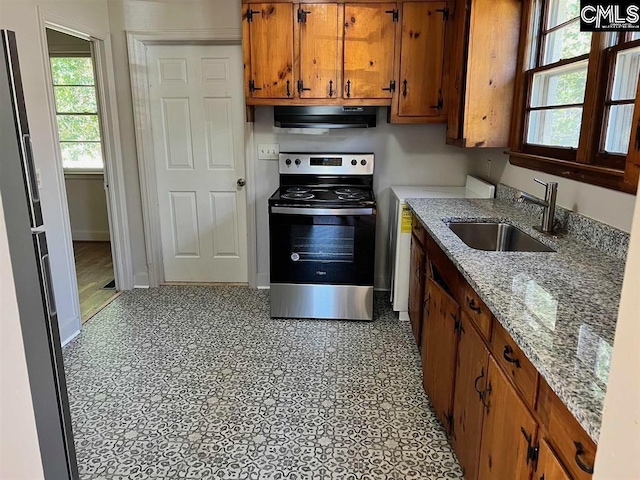 4101 Ridgewood Ave, Columbia, SC 29203 - kitchen with stainless steel electric stove, extractor fan, a sink, brown cabinets, and baseboards
