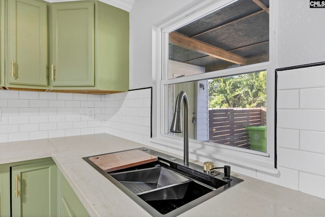 3509 Baywater Dr, Columbia, SC 29209 - kitchen with green cabinetry, a sink, backsplash, and light stone counters