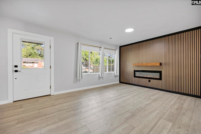 3509 Baywater Dr, Columbia, SC 29209 - unfurnished living room with a glass covered fireplace, plenty of natural light, and light wood-style flooring