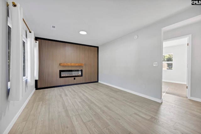 3509 Baywater Dr, Columbia, SC 29209 - unfurnished living room with a glass covered fireplace, light wood-style flooring, and baseboards