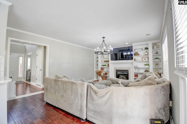 113 Dutch Oaks Dr, Irmo, SC 29063 - living room with a glass covered fireplace, dark wood-type flooring, a chandelier, crown molding, and baseboards