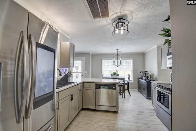 113 Dutch Oaks Dr, Irmo, SC 29063 - kitchen with appliances with stainless steel finishes, a peninsula, crown molding, a sink, and a textured ceiling