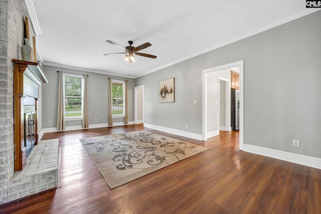 101 Stephenson Ln, Columbia, SC 29212 - unfurnished living room featuring ceiling fan, a brick fireplace, ornamental molding, and wood finished floors