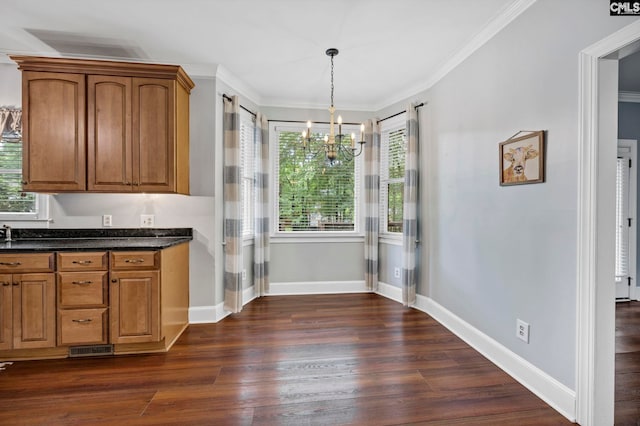 101 Stephenson Ln, Columbia, SC 29212 - kitchen with a chandelier, brown cabinetry, dark wood-style floors, baseboards, and crown molding