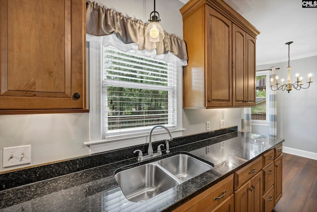 101 Stephenson Ln, Columbia, SC 29212 - kitchen featuring a sink, a chandelier, crown molding, dark wood-style flooring, and brown cabinetry