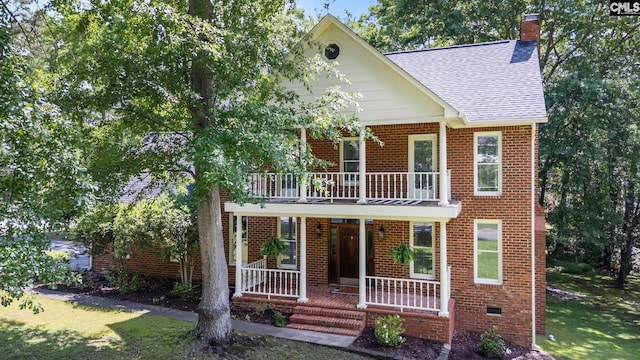 101 Stephenson Ln, Columbia, SC 29212 - view of front facade featuring a balcony, covered porch, a shingled roof, a chimney, and brick siding