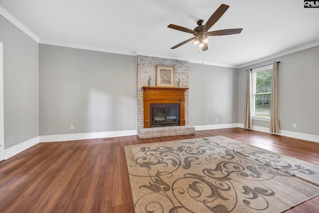 101 Stephenson Ln, Columbia, SC 29212 - unfurnished living room with a ceiling fan, wood finished floors, crown molding, a brick fireplace, and baseboards