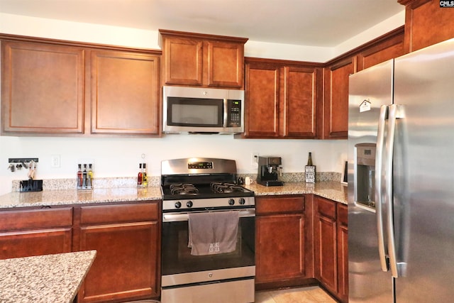542 Pineberry Ct, West Columbia, SC 29170 - kitchen featuring appliances with stainless steel finishes, light stone counters, and light tile patterned floors