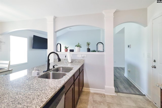 542 Pineberry Ct, West Columbia, SC 29170 - kitchen with a sink, light stone counters, dark brown cabinetry, dishwasher, and light tile patterned flooring