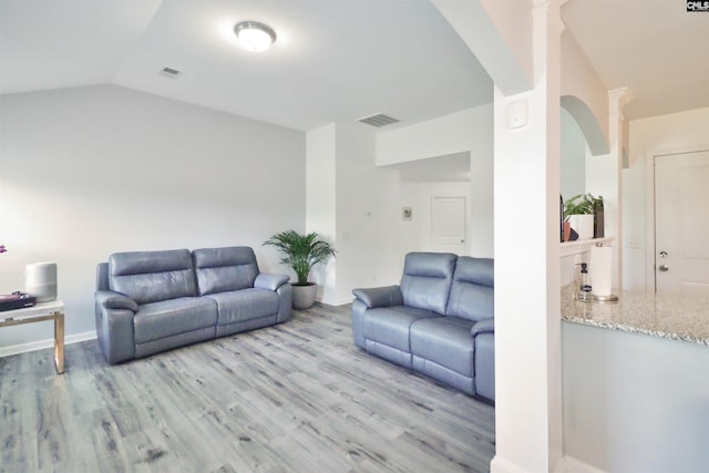 542 Pineberry Ct, West Columbia, SC 29170 - living room featuring light wood-style flooring, arched walkways, lofted ceiling, and baseboards