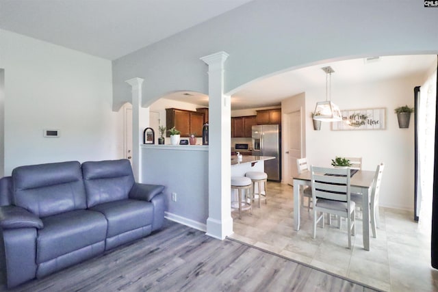 542 Pineberry Ct, West Columbia, SC 29170 - living room featuring light wood-style floors, decorative columns, and arched walkways