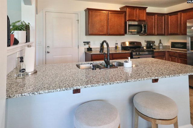 542 Pineberry Ct, West Columbia, SC 29170 - kitchen with appliances with stainless steel finishes, a sink, light stone countertops, and a breakfast bar