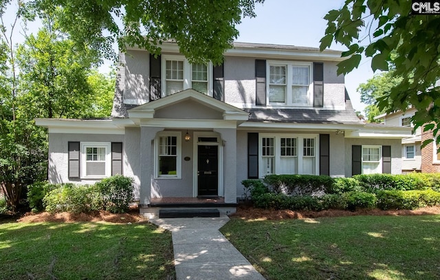 111 Southwood Dr, Columbia, SC 29205 - view of front of home with stucco siding, a porch, and a front lawn