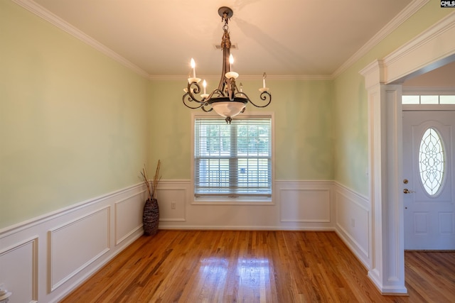 6126 Slab Landing Dr, Cope, SC 29038 - unfurnished dining area featuring a chandelier, wood finished floors, a wainscoted wall, crown molding, and a decorative wall