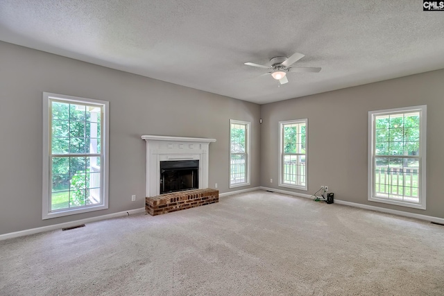 198 Beaver Creek Cir, Lugoff, SC 29078 - unfurnished living room featuring a textured ceiling, a ceiling fan, carpet floors, baseboards, and healthy amount of natural light