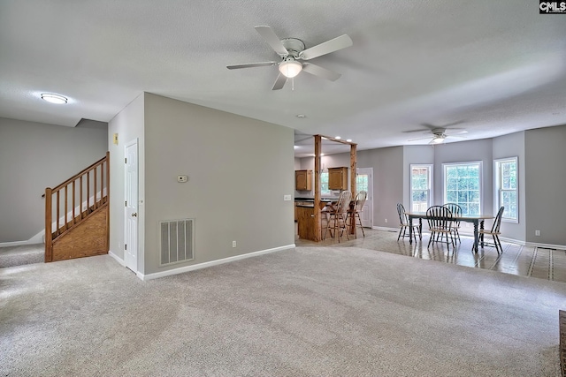 198 Beaver Creek Cir, Lugoff, SC 29078 - living area featuring a ceiling fan, light carpet, baseboards, and stairway