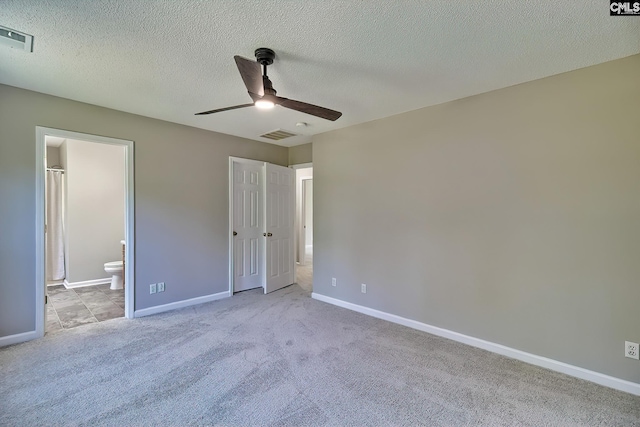 198 Beaver Creek Cir, Lugoff, SC 29078 - unfurnished bedroom featuring carpet, connected bathroom, baseboards, and a textured ceiling