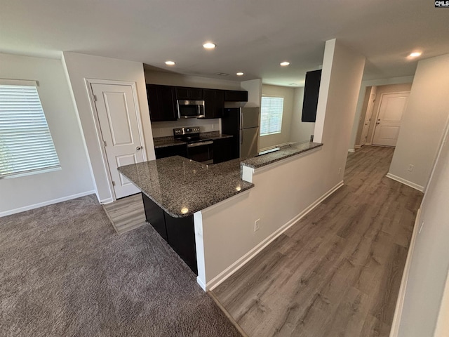 184 Windfall Rd, Blythewood, SC 29016 - kitchen featuring stainless steel appliances, dark cabinetry, dark stone countertops, recessed lighting, and baseboards