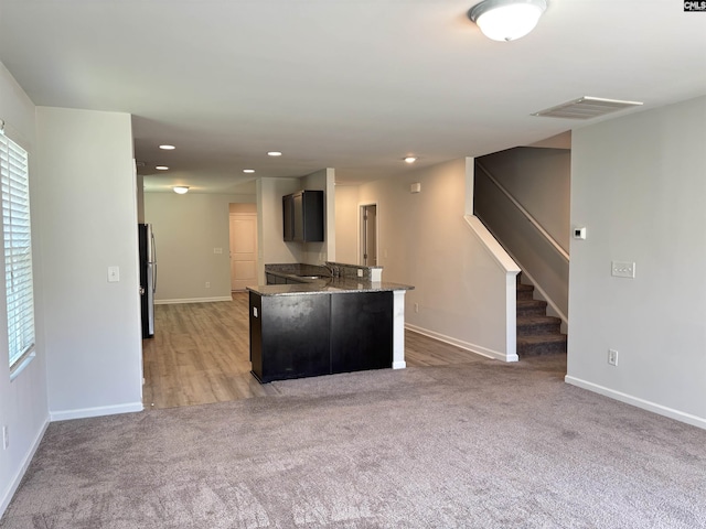 184 Windfall Rd, Blythewood, SC 29016 - kitchen with baseboards, light carpet, recessed lighting, a sink, and a peninsula