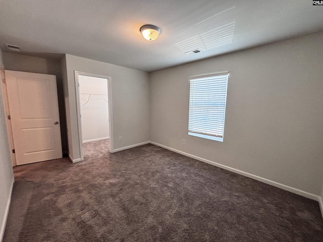 184 Windfall Rd, Blythewood, SC 29016 - unfurnished bedroom featuring dark colored carpet, a spacious closet, baseboards, and a closet