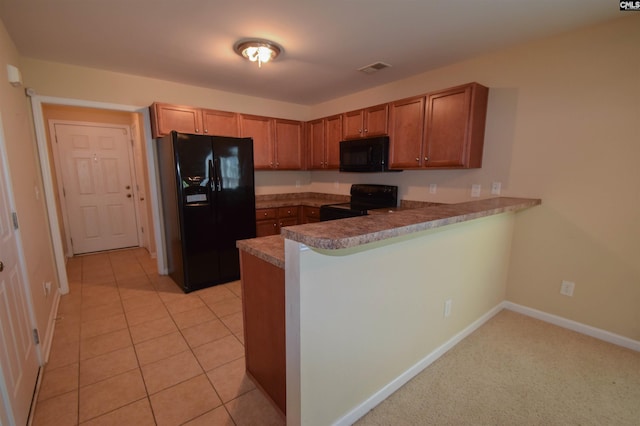 267 Courtside Dr, Lexington, SC 29073 - kitchen with black appliances, a peninsula, brown cabinetry, and baseboards